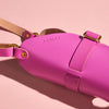 Close up picture of the pink leather water bottle carrier bag with the name 'Ashley' in stamped letters.
