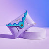 Lilac leather coin purse with blue wavy scalloped edging, with personalised letters, shown against purple and blue backdrop
