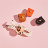Group of personalised leather cable tidies in orange, brown, black and leopard print