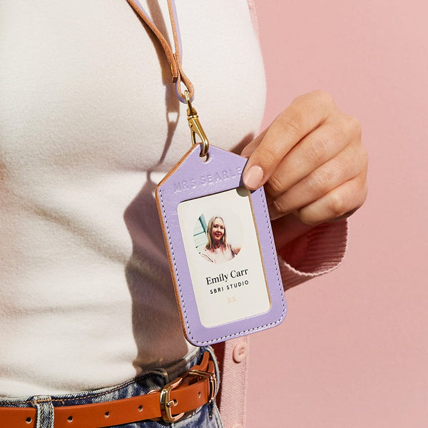 Model wearing a lilac leather lanyard and ID badge holder, personalised 'Mrs Searle'