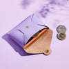 A lilac leather coin purse shown with cards and coins