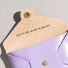 Lilac leather coin purse from Sbri with the message 'you're the main character' printed inside