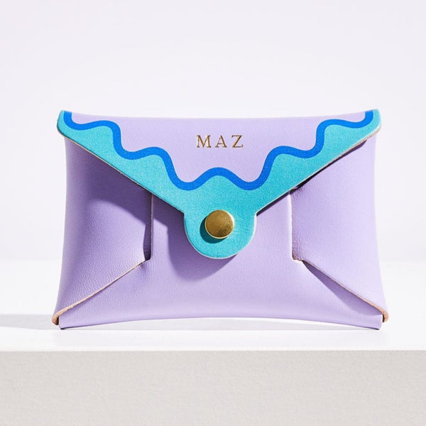 Lilac leather coin purse with blue wavy scalloped edging, with personalised letters