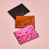 Group of leopard print Sbri card holders in pink, brown and black