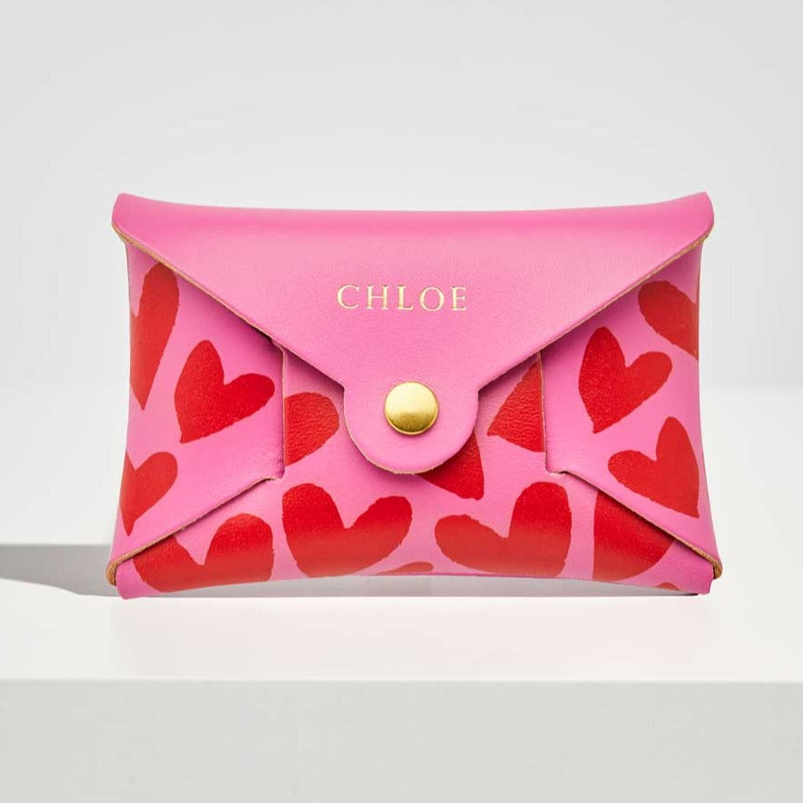 Fuchsia pink leather coin purse with red heart pattern, personalised with a name